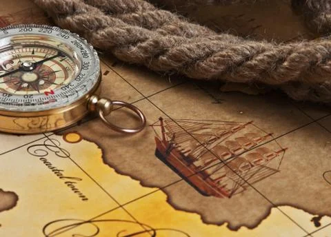 Compass and rope on map Stock Photos