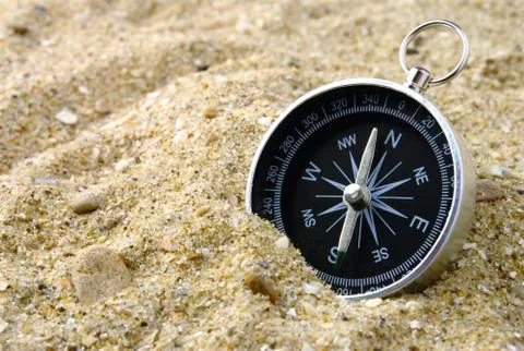 Compass and sand Stock Photos