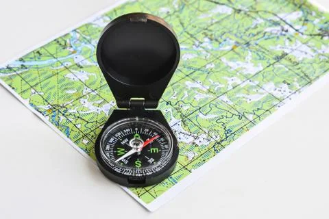 Compass and topographic map. Stock Photos