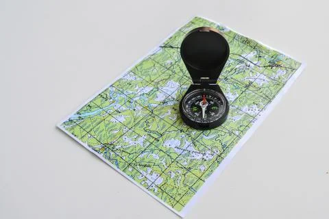 Compass and topographic map. Stock Photos