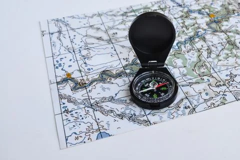 Compass and topographic map. Stock Photos