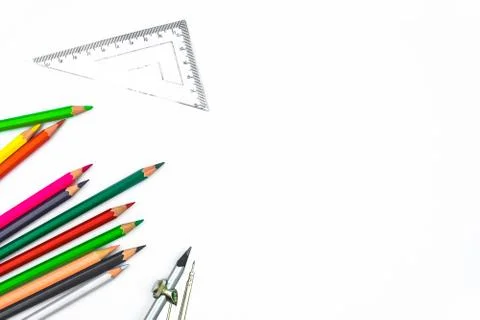 Compass attached to a pencil ,a plastic triangle and some different colored p Stock Photos