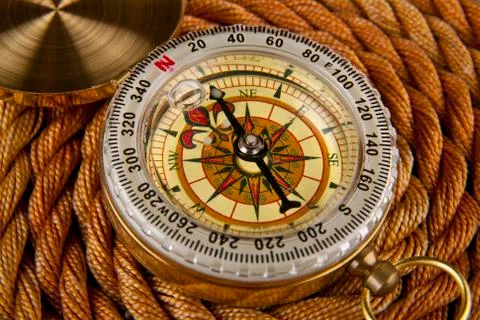 Compass on the background of the rope Stock Photos