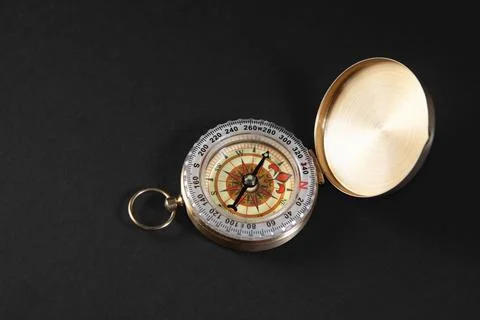 Compass on a black background. Close-up. View from above. Stock Photos