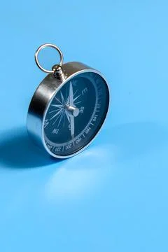 Compass on Blue Background. Navigation and Direction Concept Stock Photos