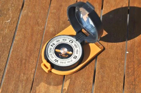 Compass on the boards. Stock Photos
