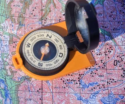 Compass cast a shadow on the map Stock Photos