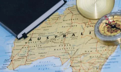 Compass on a close up map pointing at Australia and planning a travel Stock Photos
