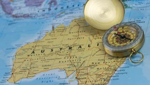 Compass on a close up map pointing at Australia and planning a travel Stock Photos