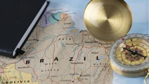 Compass on a close up map pointing at Brazil and planning a travel destination. Stock Photos