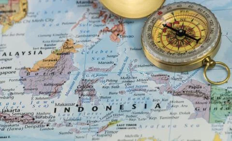 Compass on a close up map pointing at Indonesia and planning a travel Stock Photos