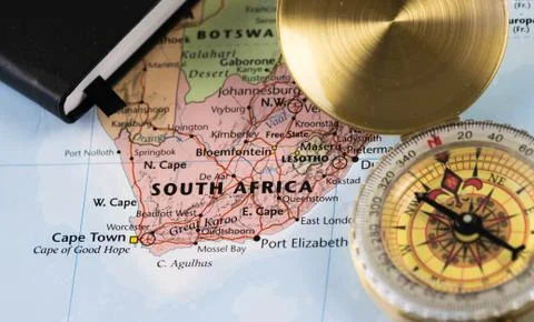 Compass on a close up map pointing at South Africa and planning a travel Stock Photos