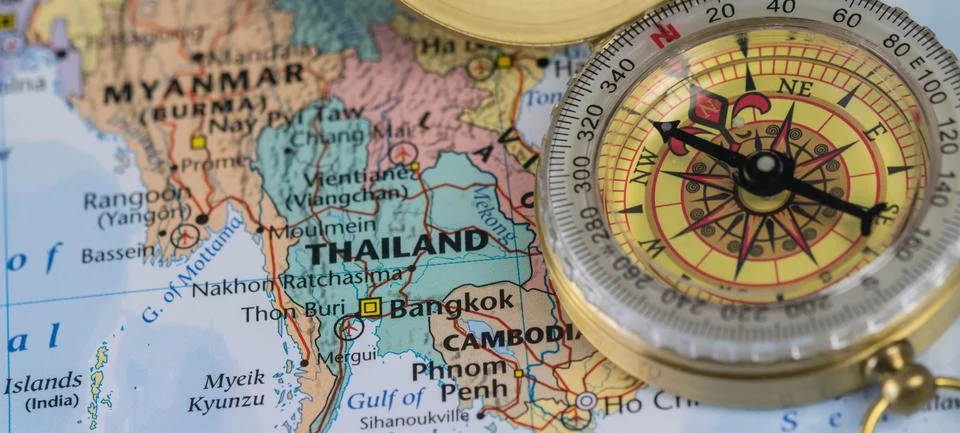 Compass on a close up map pointing at Thailand and planning a travel destination Stock Photos