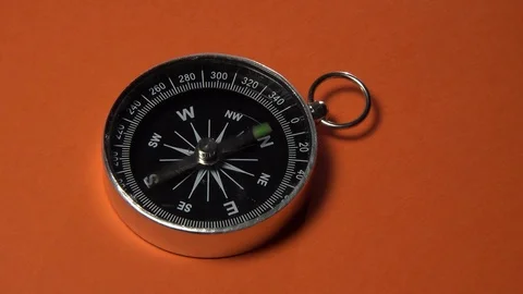 Compass closeup on red background Stock Footage 73663658