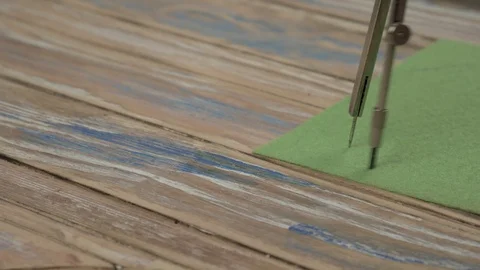 Compass draws a circle on a green background. Tools for drawing. Creating a Stock Footage 103592083