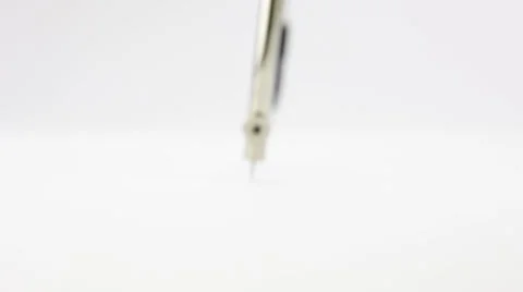 A compass draws a figure on a paper sheet Stock Footage 34233689