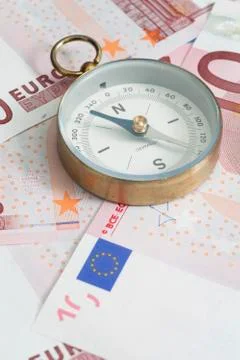Compass on Euro banknotes Stock Photos