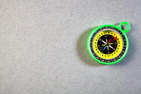 Compass in the form of a toy on a black background. Stock Photos