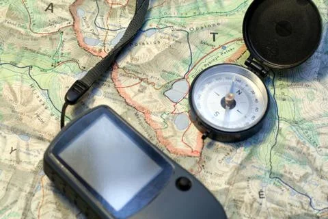 Compass with a GPS device on a topographic map Stock Photos