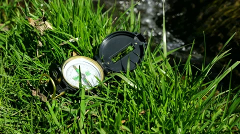 Compass on the grass near litle stream Stock Footage 62429865