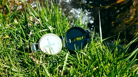 Compass on the grass near litle stream Stock Footage 62432950
