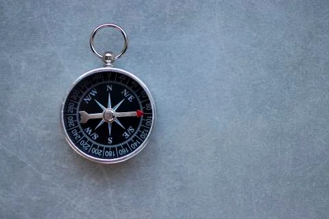 Compass on a gray background. Copy space. Stock Photos