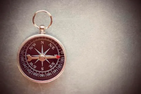 Compass on a gray background. Copy space. Stock Photos