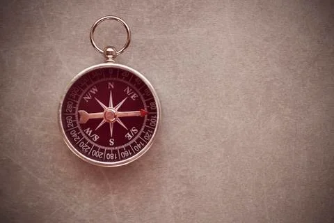 Compass on a gray background. Copy space. Stock Photos