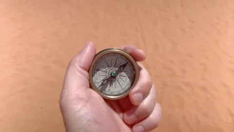 Compass in hand on dry desert area 스톡 동영상 113151606