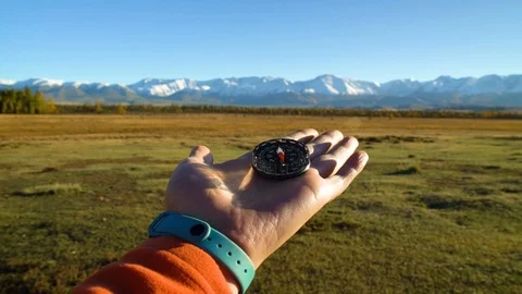 Compass in hand at mountains terrain Stock-Footage 101223965