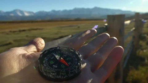 Compass in hand at mountains terrain Video stock 101224668