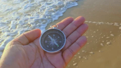 Compass in hand on sea beach background Stock-Footage 163138212