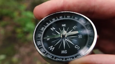 Compass in the hands of a man close up Stock Footage 133371625