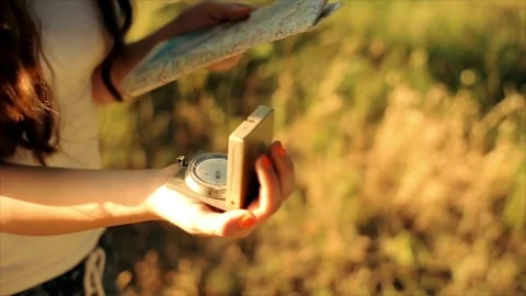 Compass in hands for searching direction outdoor. Using a compass for guida.. Stock Footage 257870233