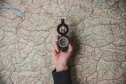 Compass   held   above   world   map Stock Photos