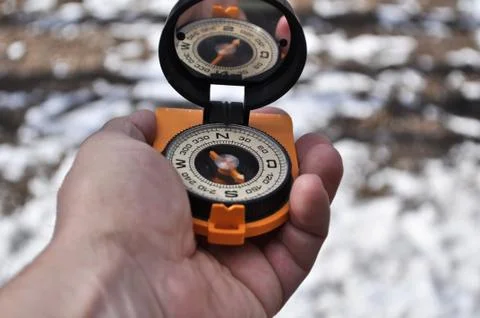 The compass in his hand. Stock Photos
