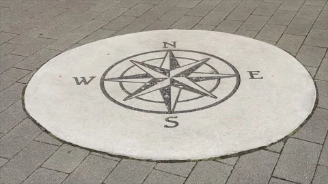 Compass illustration print on circle cement pavement concrete slab in black Stock Footage 249421452