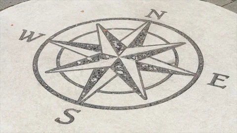 Compass illustration print on circle cement pavement concrete slab in black Stock Footage 249421481