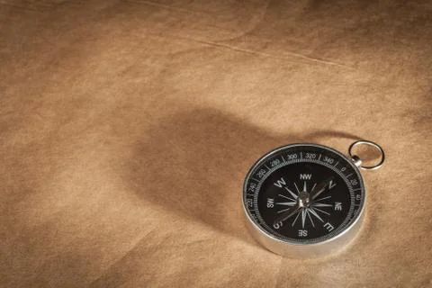 Compass on light brown background Stock Photos