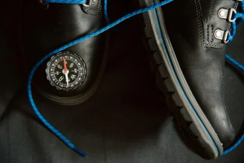 Compass lying on shoes Stock Photos