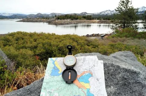 Compass, map and lake Stock Photos