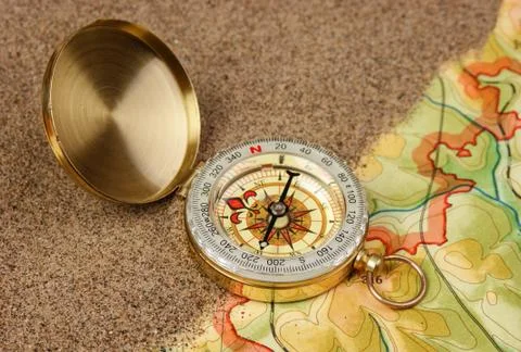 Compass on the map with sand Stock Photos