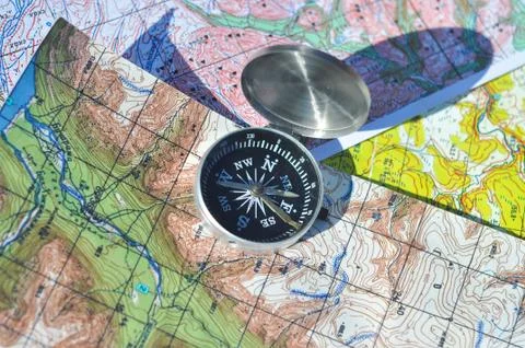 Compass on the maps. Stock Photos
