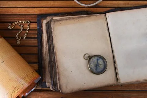 Compass on old book Stock Photos