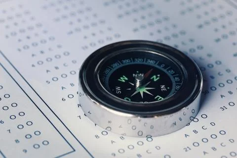 Compass on optical answer sheet. Stock Photos