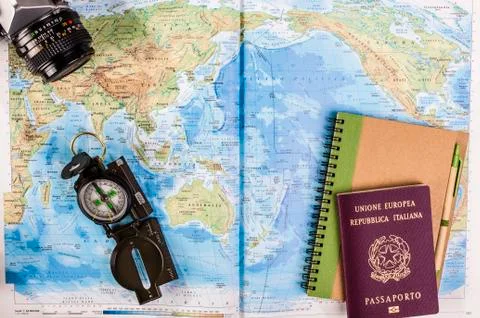 Compass, passport and block notes on map Stock Photos