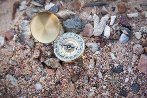Compass on pebbles as background Stock Photos