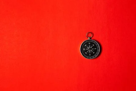 Compass on red background. Concept signs symbols. Stock Photos