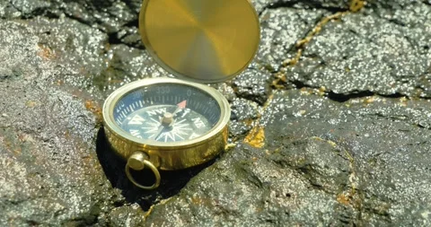 Compass Resting on Rocky Surface Outdoors Stock Footage 323570327