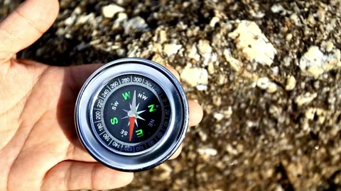 Compass with rock background. round compass on natural background Stock Footage 257870170